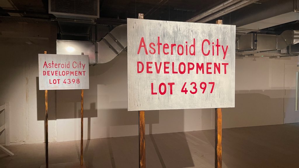 A sign depicting a lot for sale in the fictitious Asteroid City. Taken at the exhibition of props from the Wes Anderson film.