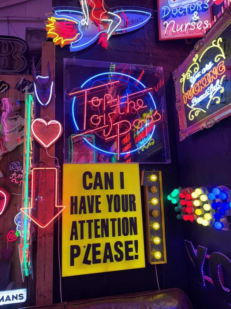 A red neon sign saying Top Of The Pops at God's Own Junkyard - a museum dedicated to neon signs.