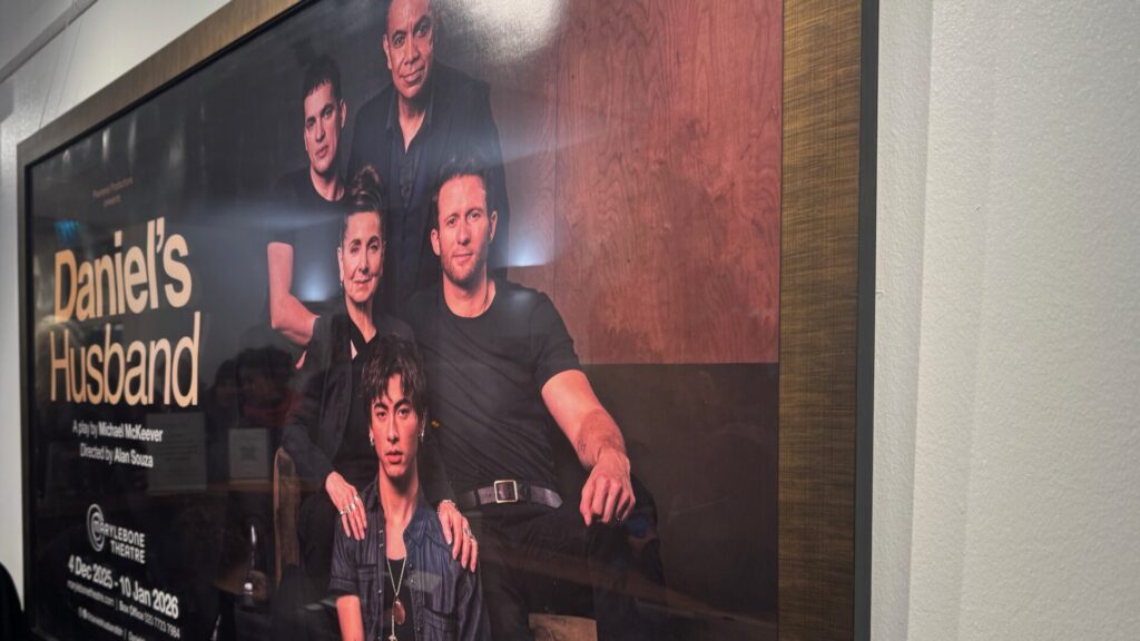 Theatre poster for 'Daniel's Husband' showing five people in black clothing posed together against a dark background, with production details including playwright Michael McKeever and director Alan Souza, displayed at Marylebone Theatre for performances from 4 December 2025 to 10 January 2026