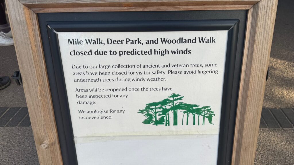 Wooden-framed notice at Attingham Park, Shropshire, announcing the closure of the Mile Walk, Deer Park and Woodland Walk because of predicted high winds.